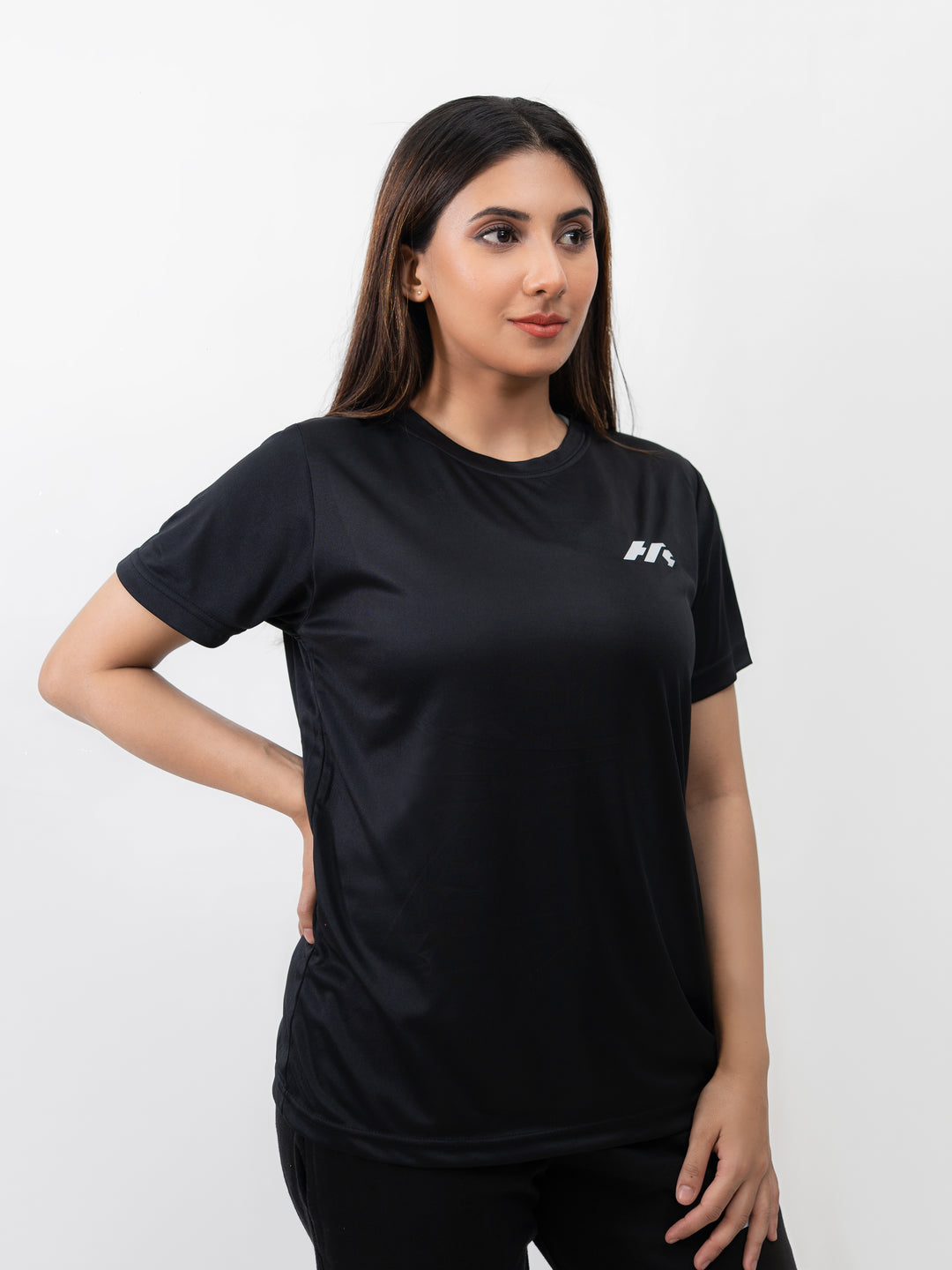 Close-up of reflective HK logo on black dri-fit workout shirt