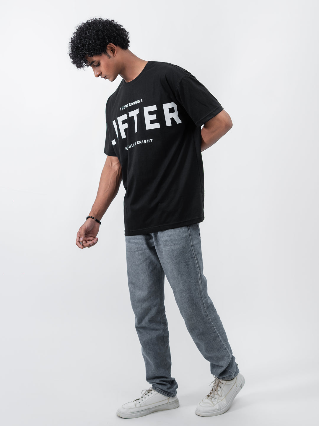 Model wearing black Galactic Knight drop shoulder tee by Herculean Knight, 100% cotton, size XL, streetwear + gym fusion