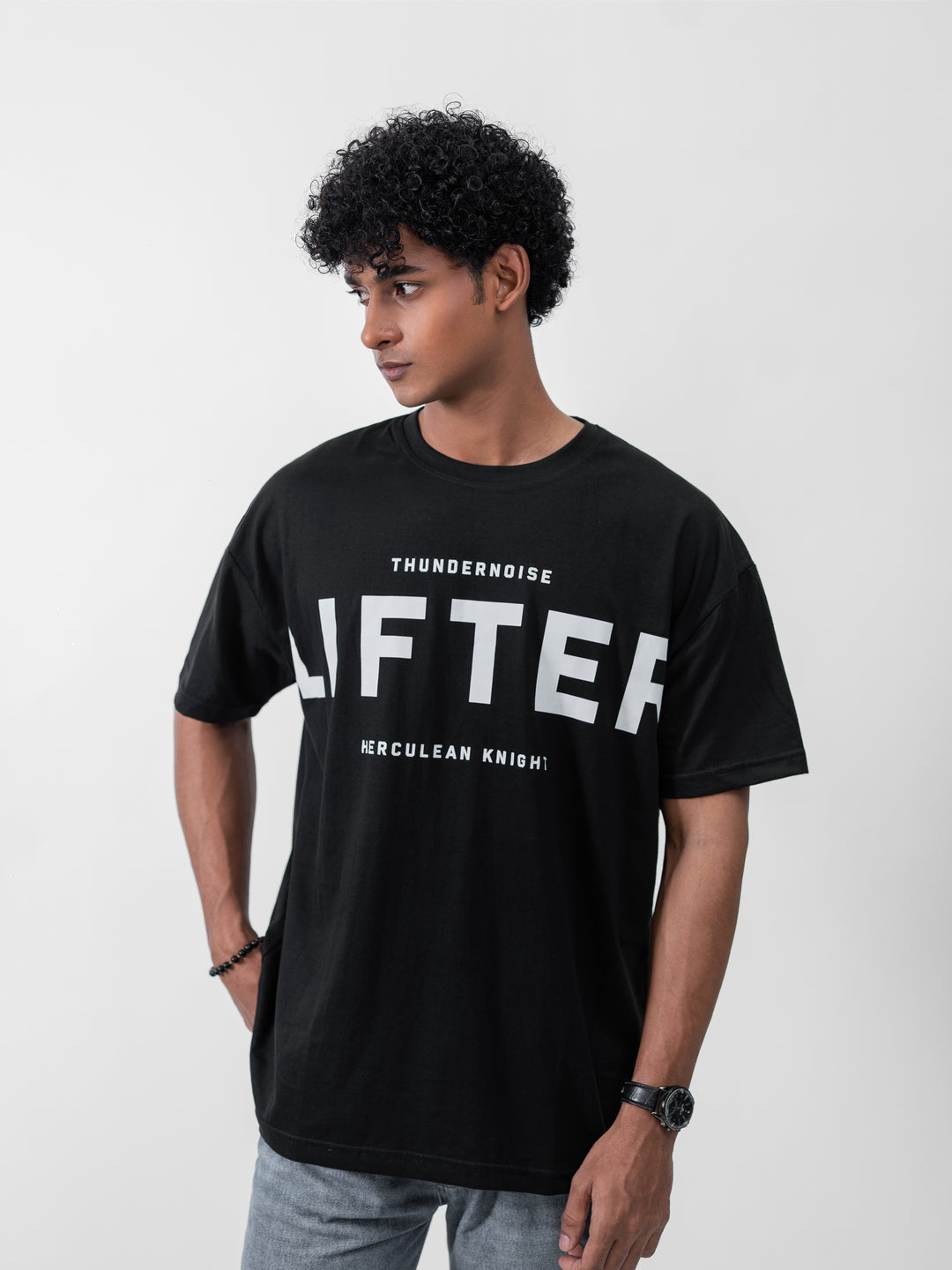 Model wearing black Galactic Knight drop shoulder tee by Herculean Knight, 100% cotton, size XL, streetwear + gym fusion