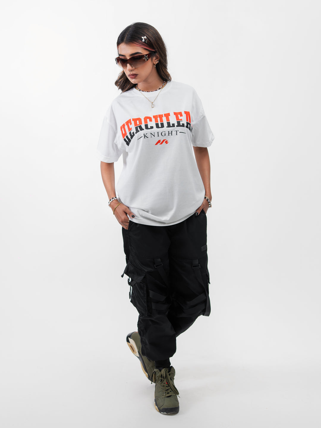 Woman 5ft2 in XL Herculean Knight white oversized drop-shoulder gym tee with orange graphic