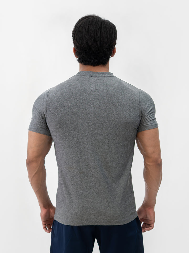 Male athlete 5 ft 8 in wearing size S Herculean Metal Grey Dri-Blend Training Tee, hands on hips, front view against white background.