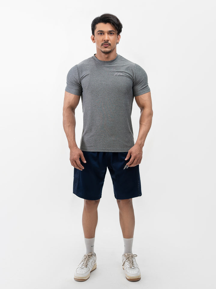 Male athlete 5 ft 8 in wearing size S Herculean Metal Grey Dri-Blend Training Tee, hands on hips, front view against white background.