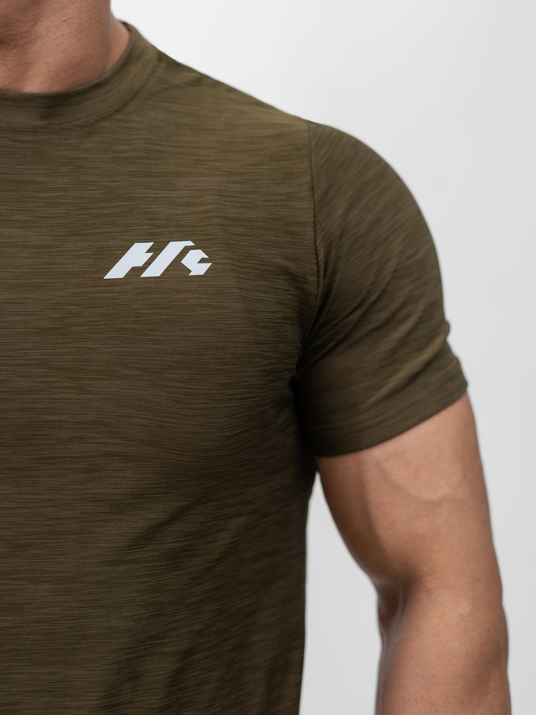 Close-up of moisture-wicking Lycra fabric on Herculean olive workout shirt