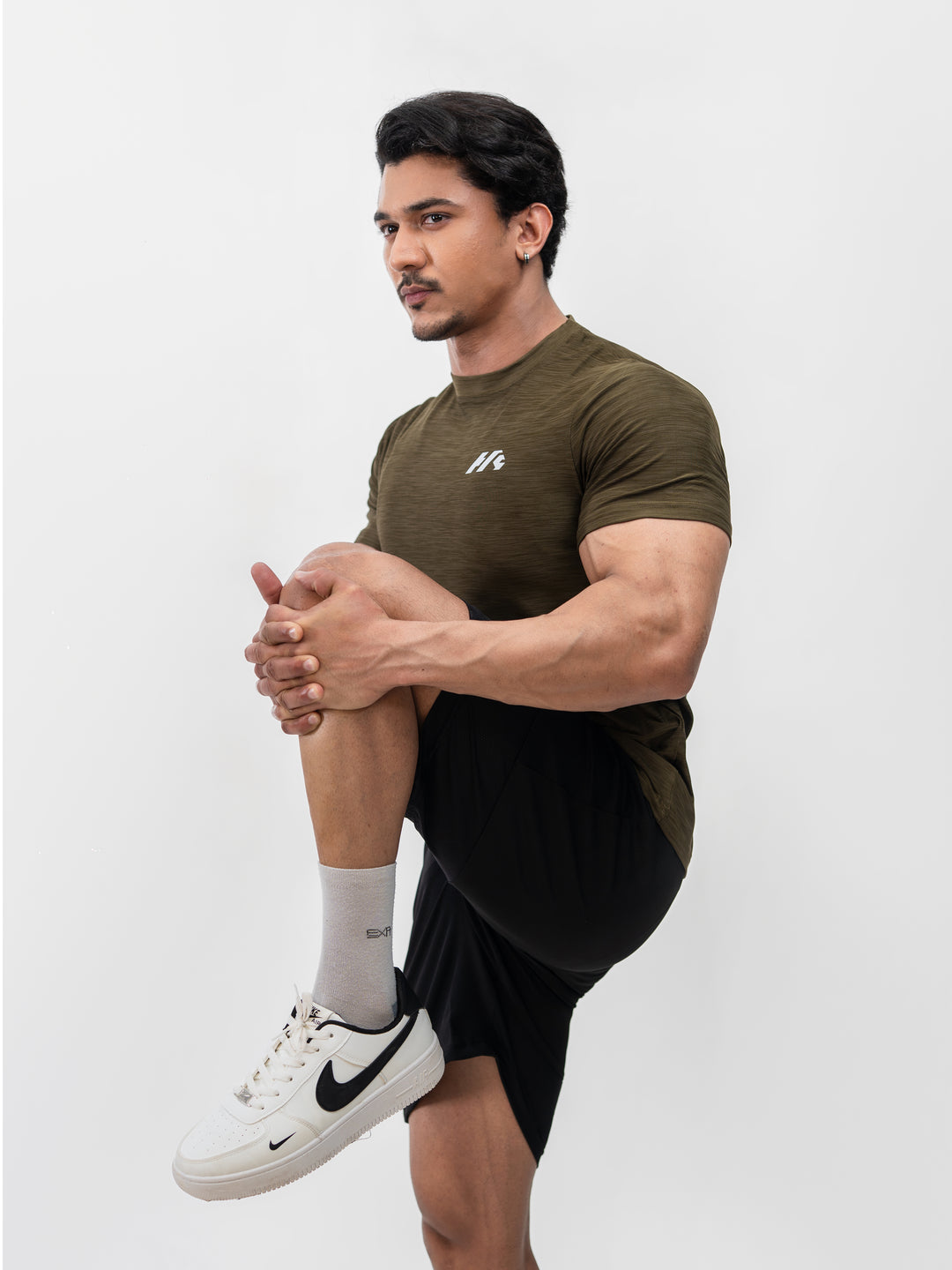 Close-up of moisture-wicking Lycra fabric on Herculean olive workout shirt