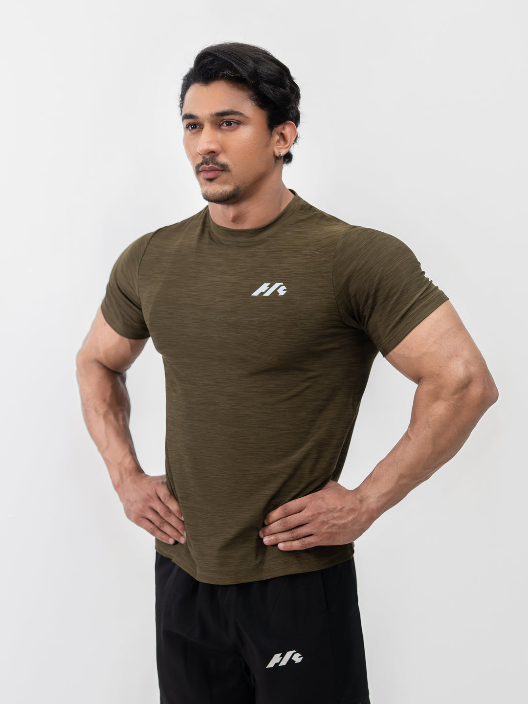 Close-up of moisture-wicking Lycra fabric on Herculean olive workout shirt